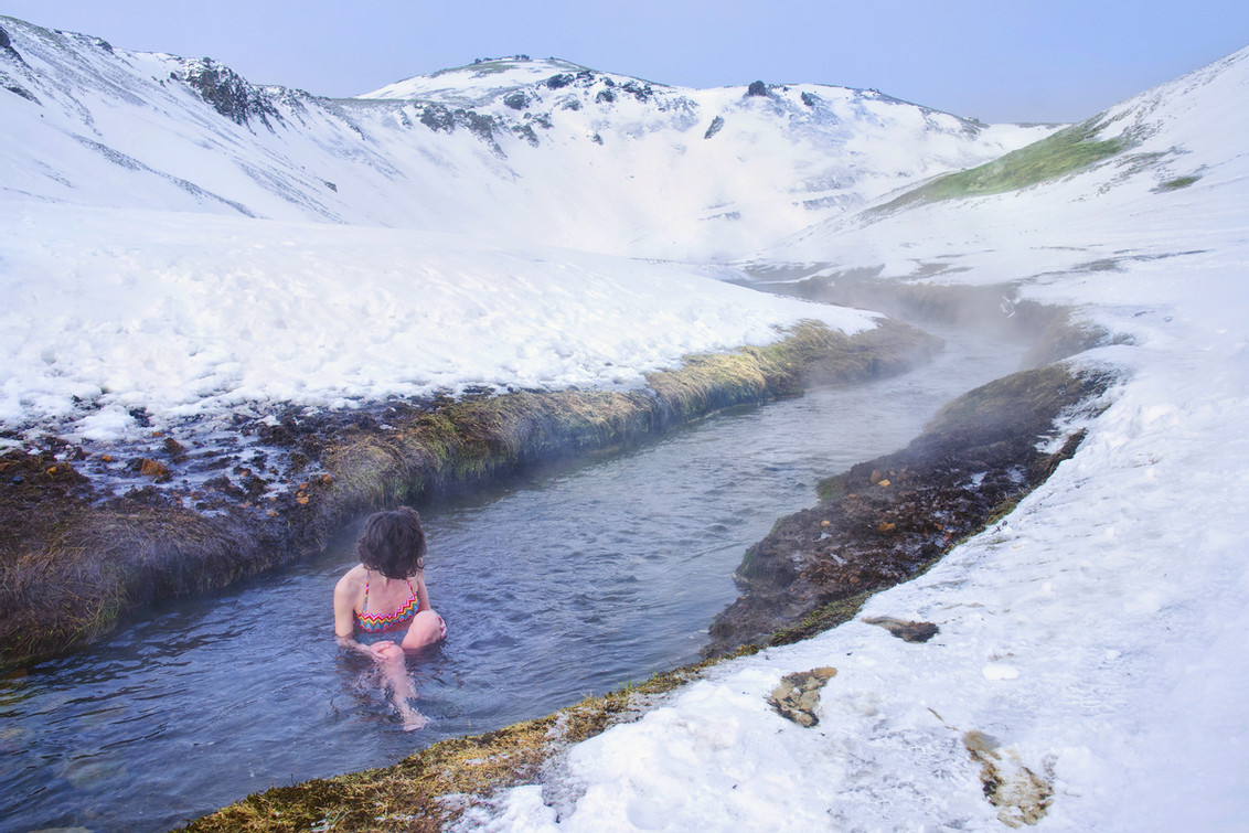 Woman in Icelands hot river in the winter