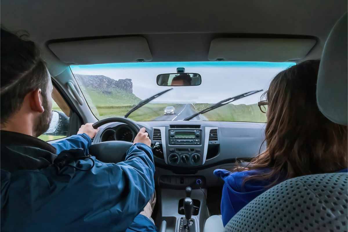 Couple driving their car on a rainy day in Iceland's main road
