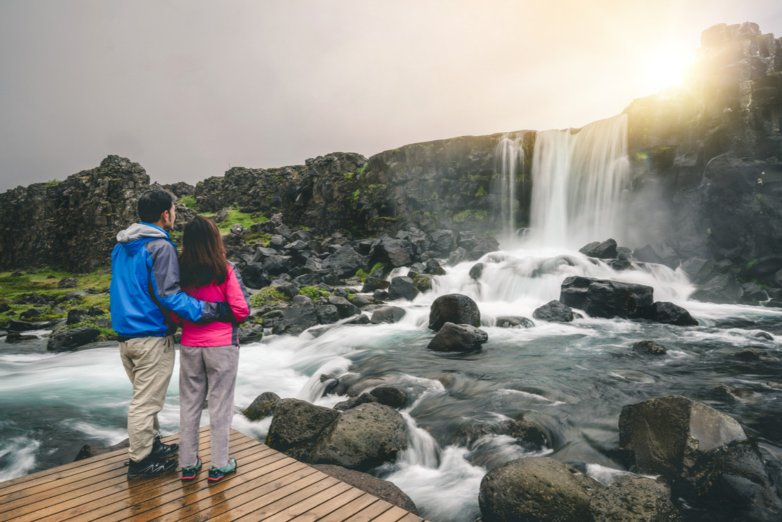 Iceland national park Thingvellir couple at waterfall