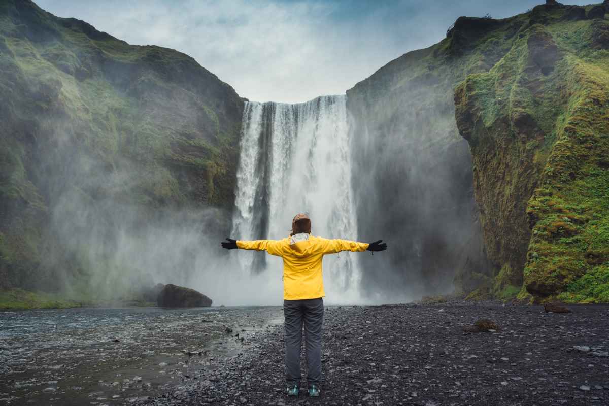 Girl enjoying the lovely views of a waterfall in Iceland