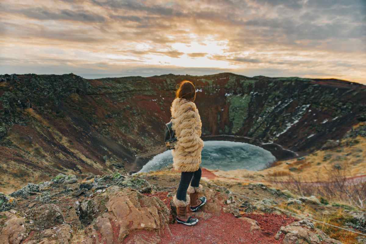 Man working remotely in Iceland sitting by a geothermal hot spring