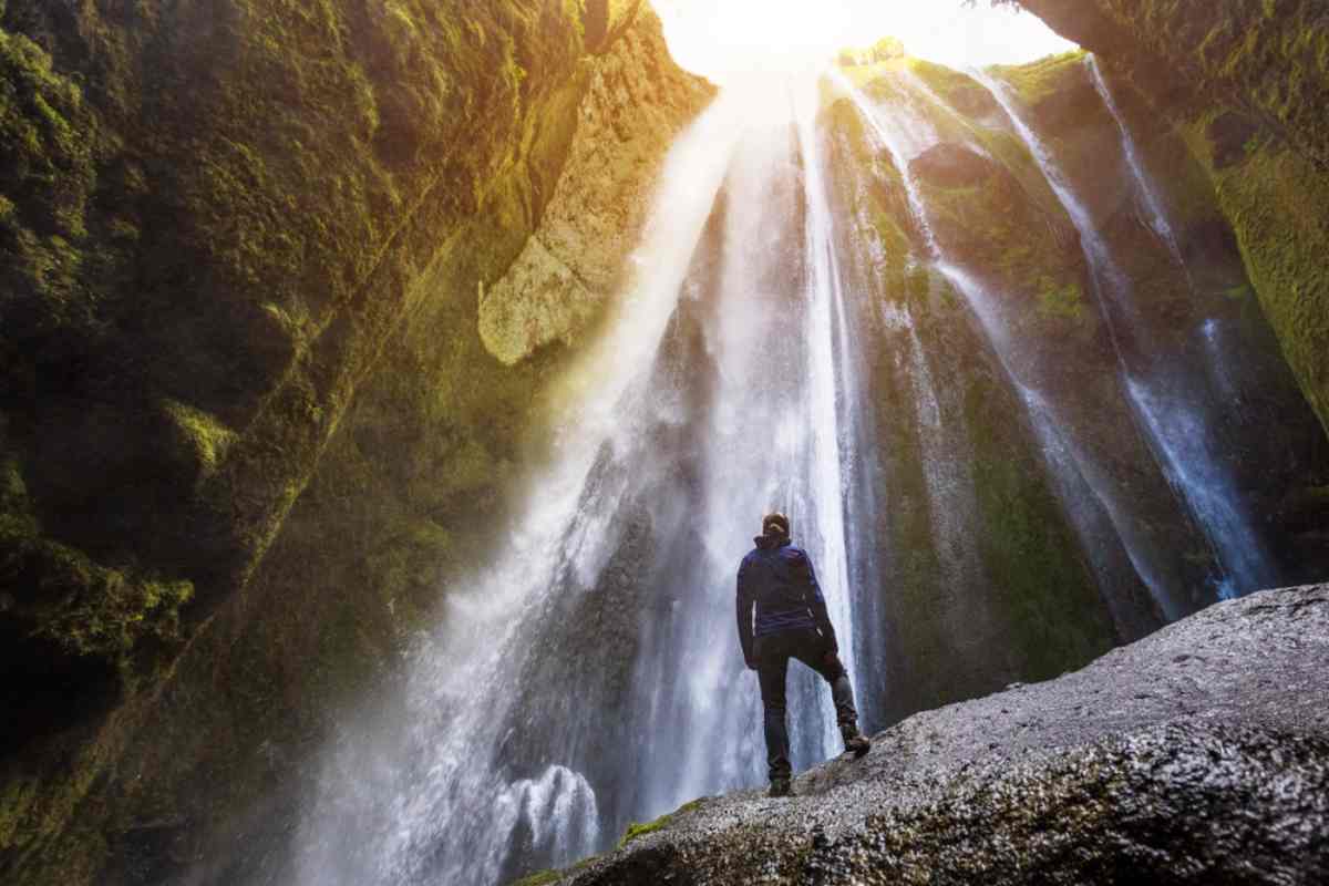 Man working remotely in Iceland sitting by a geothermal hot spring