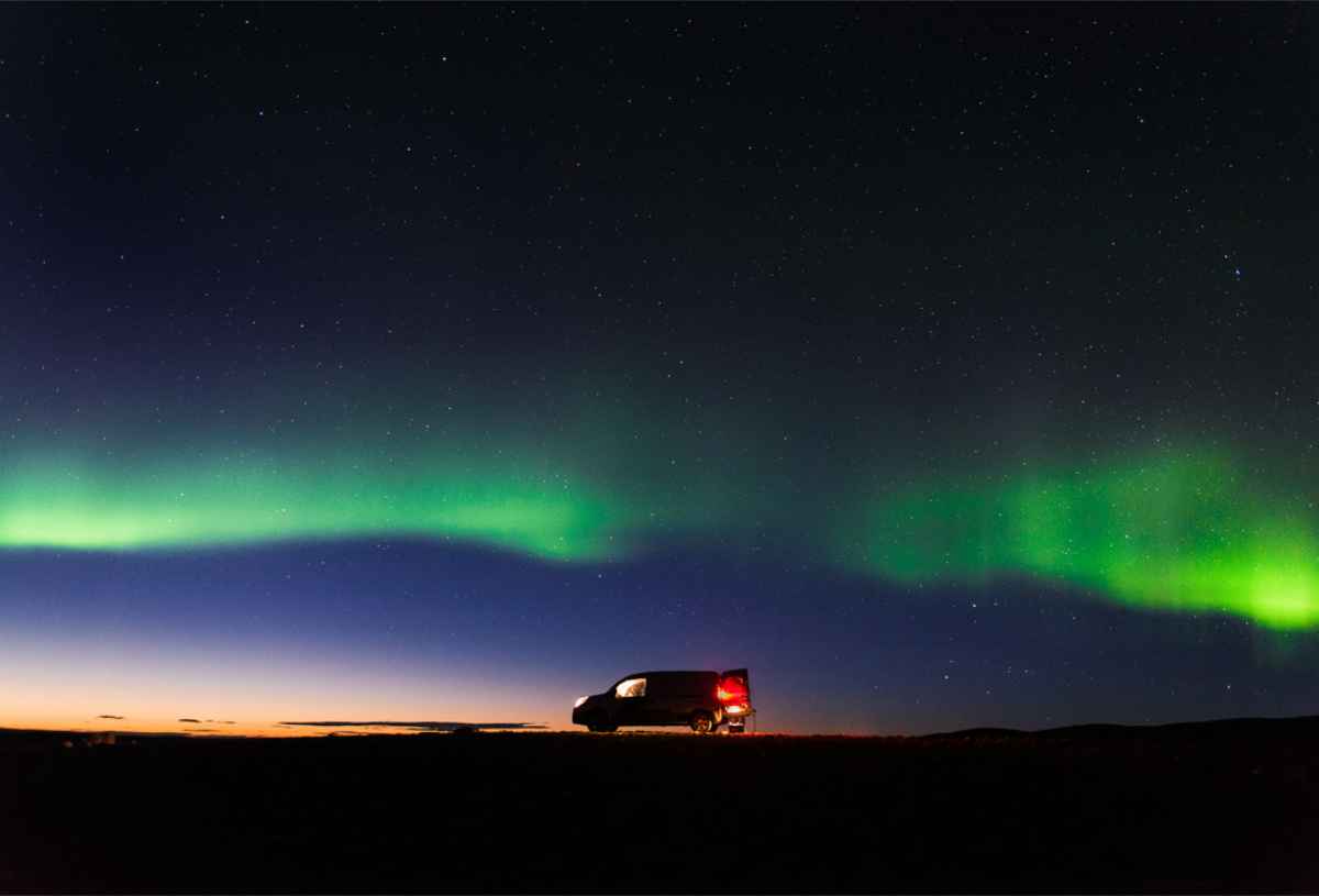 Northern lights on top of a campervan in Iceland