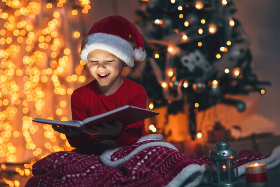 kid reading books on christmas day