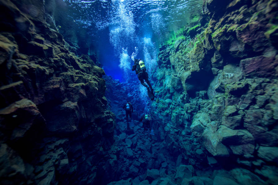 Divers in Silfra fissure