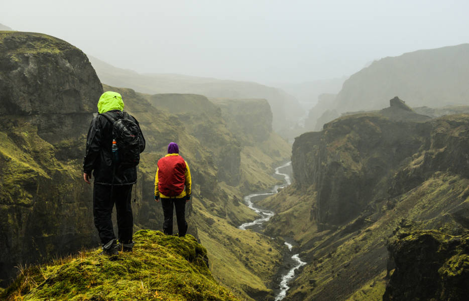 Backpackers admiring the views of an impressive canyon in Iceland