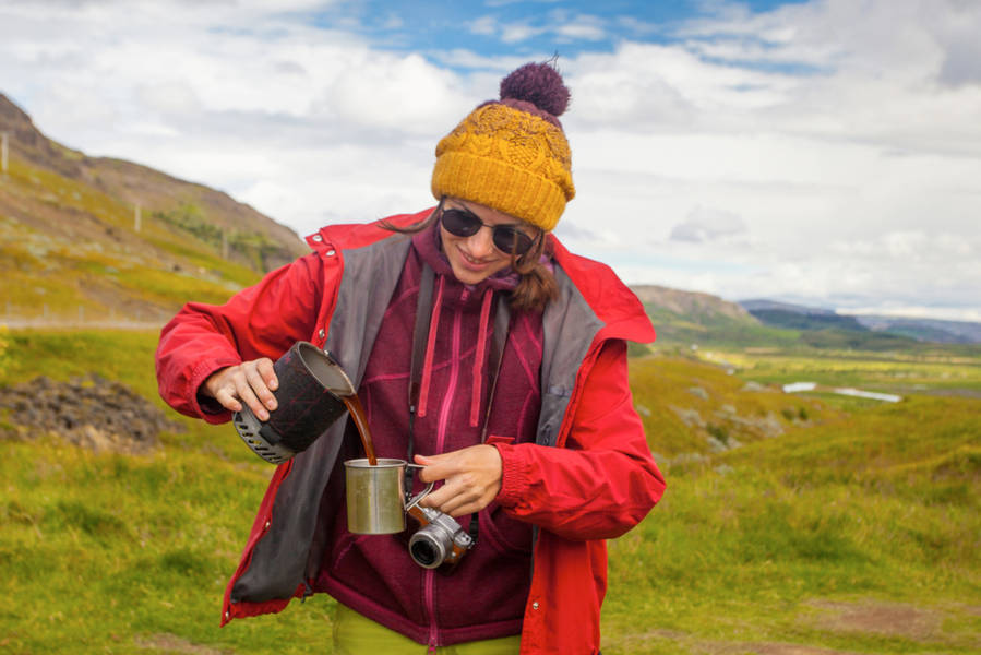 Tourist pouring herself a cup of coffee