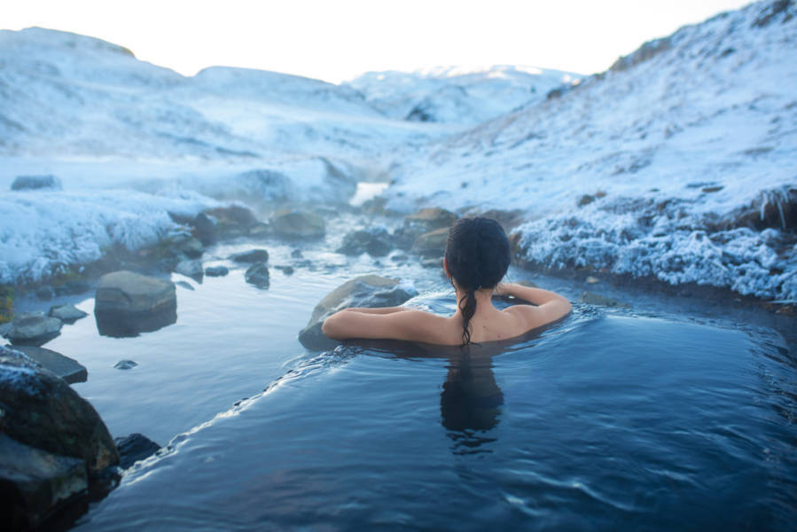 The girl bathes in a hot spring in the open air