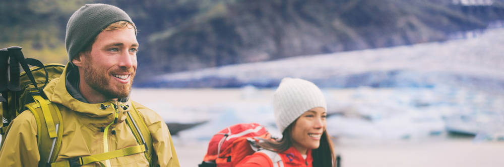 two tourists with backpacks ready for many activities in Iceland in February