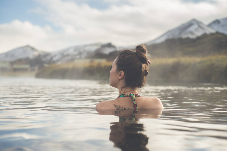 Woman relaxing in a geothermal pool in Iceland