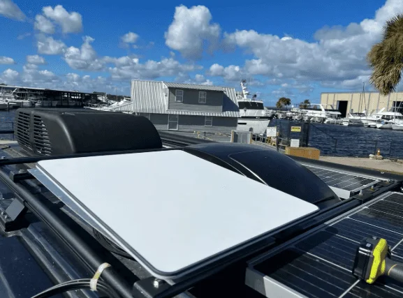 Starlink Roam satellite dish mounted on an RV roof, providing high-speed internet for remote work and off-grid travel.