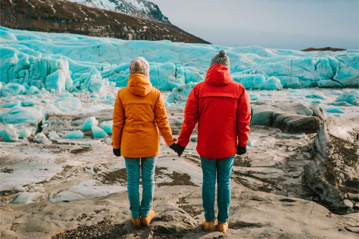 Couple enjoying the view of a glacier in front of them
