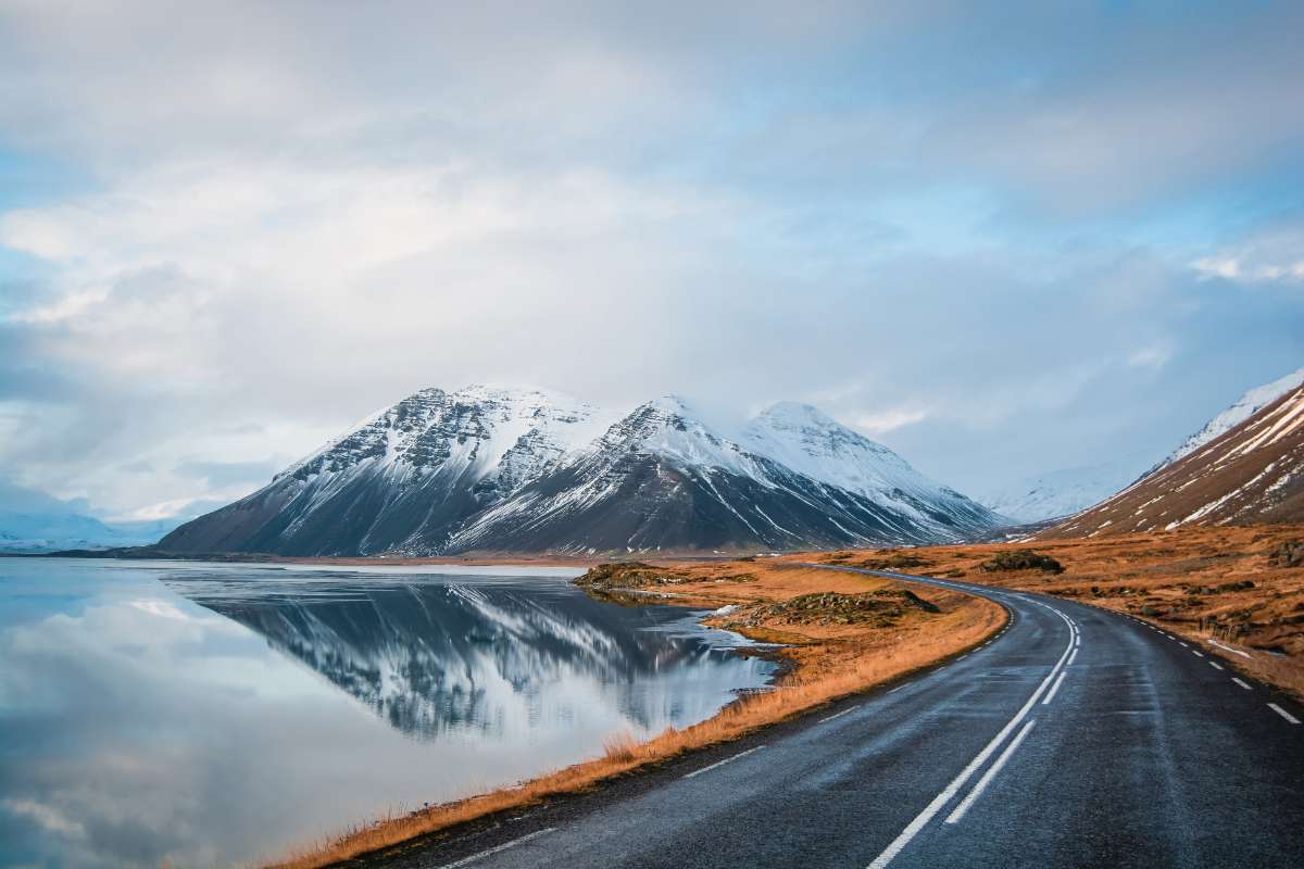 kid wheeling a carry-on bag on a road representing a road trip in Iceland with babys