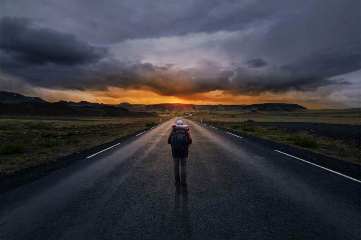 Man walking through a lonely road in Iceland