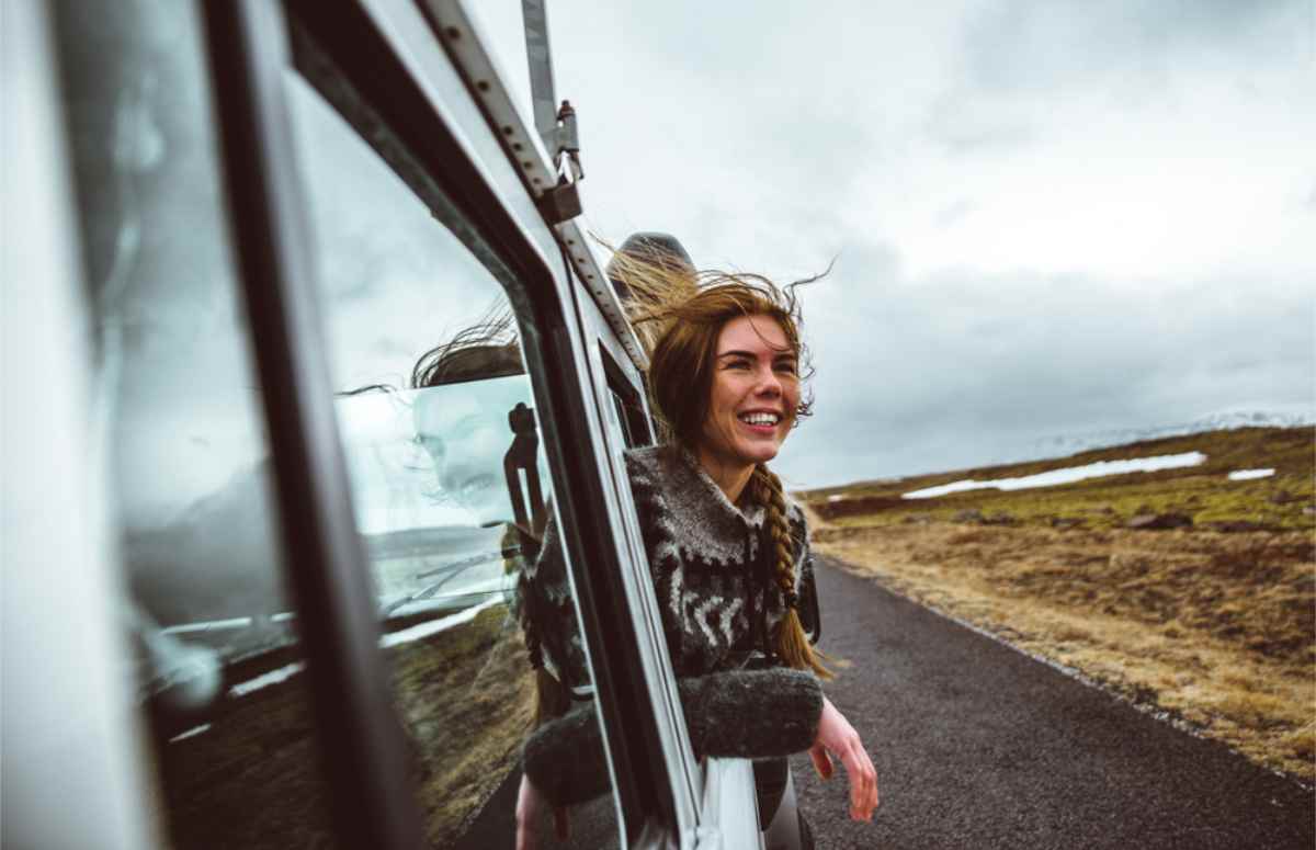 woman enjoying the wind while on the road in Iceland