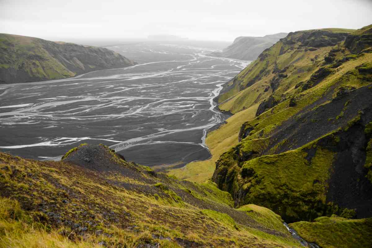  enormous moss-covered rock walls with a river valley