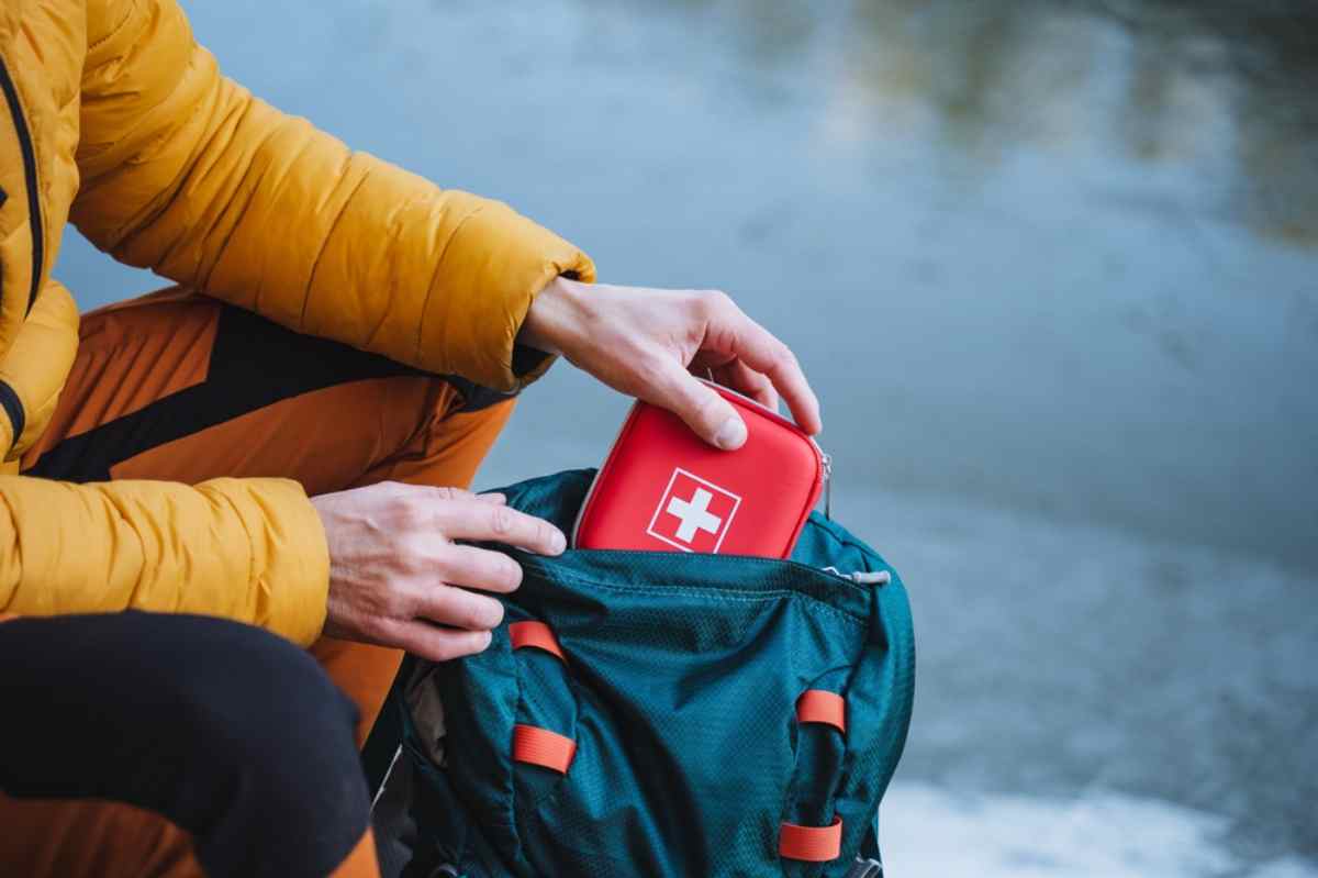 Tourist with a first aid kit in his backpack