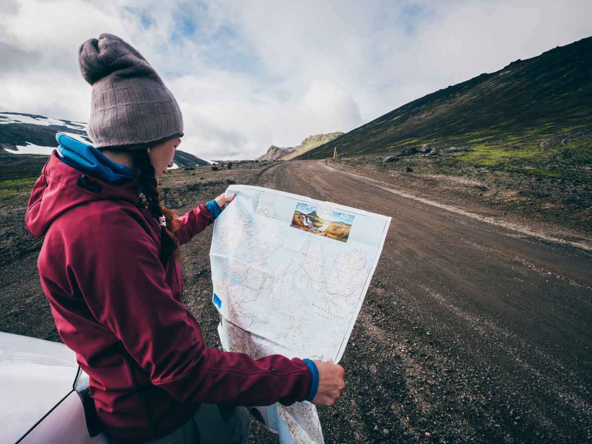 tourist holding a map for her three day itinerary in Iceland camper route