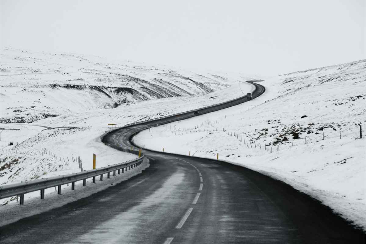 Winding Icelandic road with a snow covered landscape