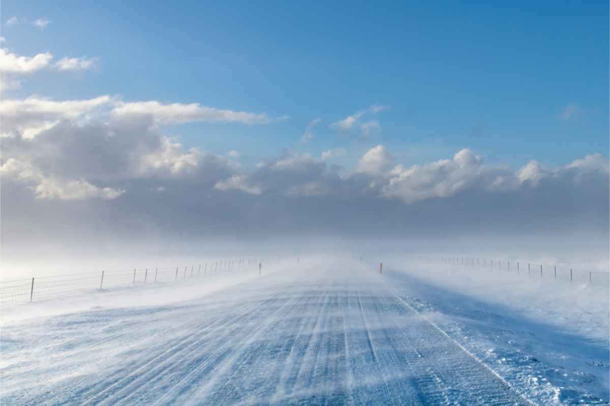 Wind blowing snow onto a road in Iceland