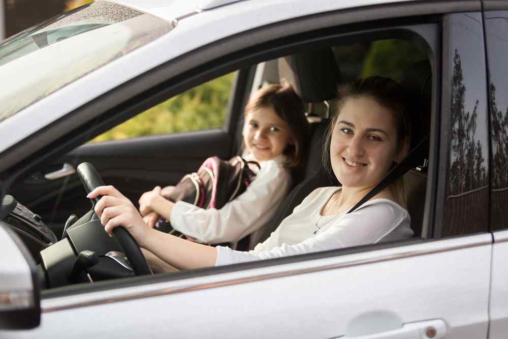 Front seat Adult and child sitting in the front seats of a car.