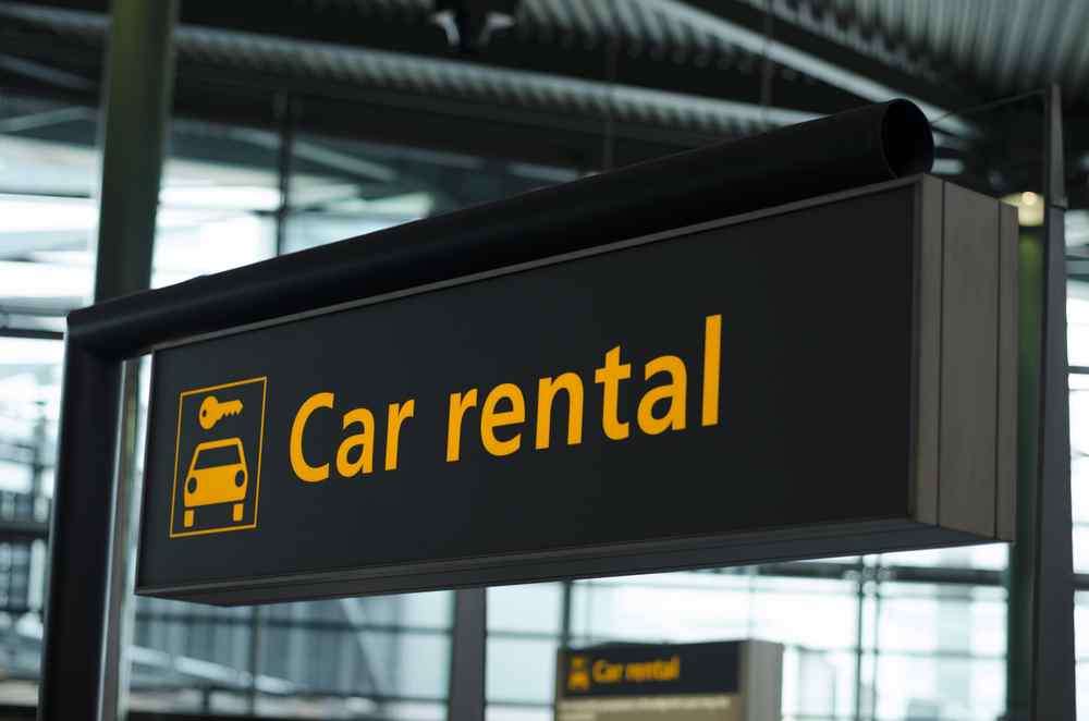 Car rental sign in Iceland Car rental sign inside an airport terminal.