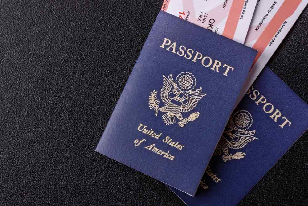 Legality of car seats in Iceland Two U.S. passports and boarding passes on a dark surface.